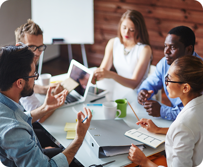 A diverse group of colleagues collaborates around a table in a bright, modern office.
