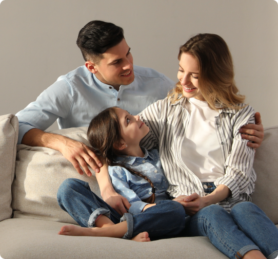 a family of 3 taking a photo with their small girl child