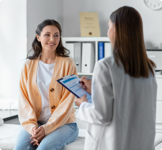 A professional woman asks questions to a provider in an office, symbolizing a clear line of communication.